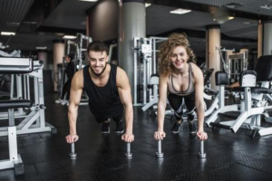 couple exercising together in gym