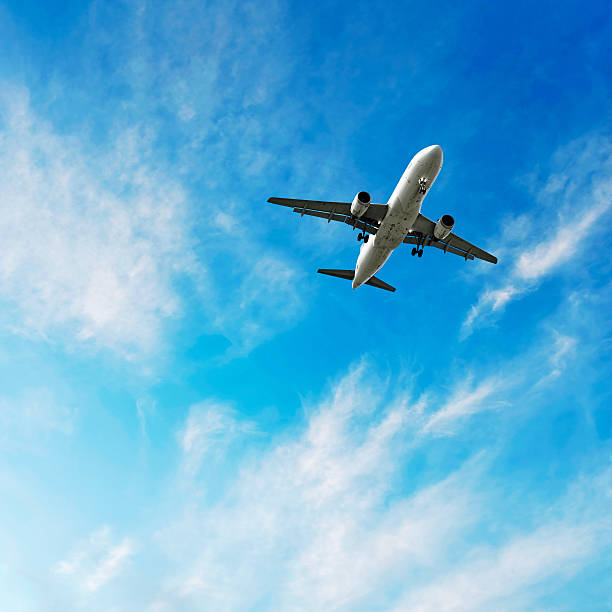 jet airplane landing in bright wispy sky, square frame (XL)