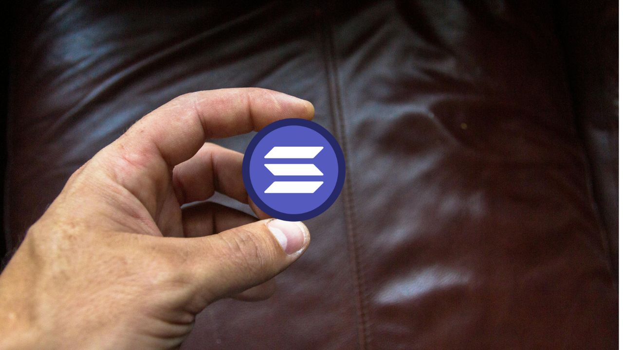 Holding a token on Solana against the dark background to represent the simplest visual representation of SPL tokens on the Solana blockchain.