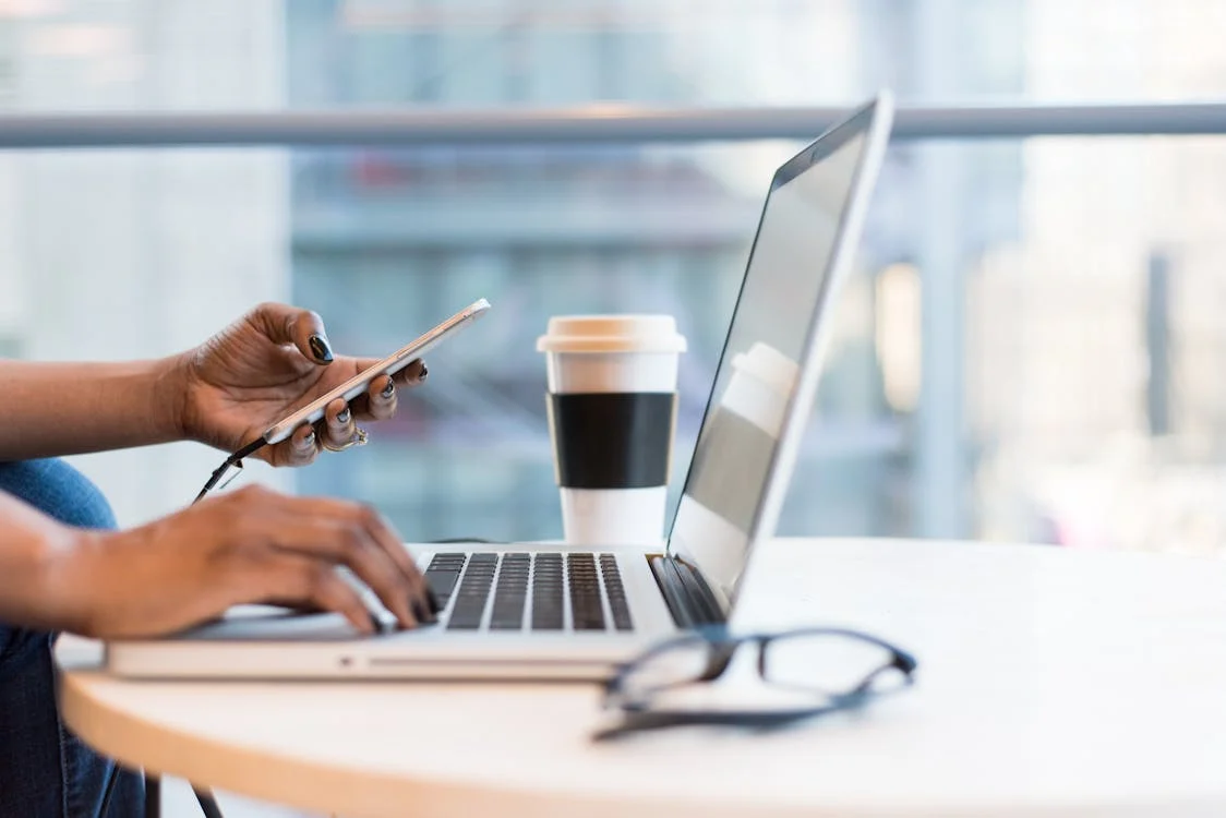 A person holding laptop and working on business branding