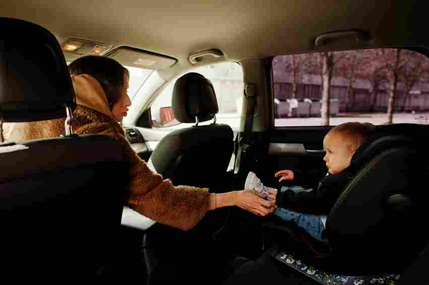 Young mother and child in car