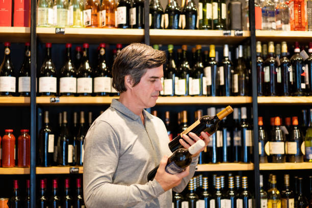 Man choosing wine in liquor store