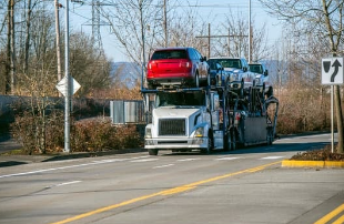 An open transport carrying vehicles for delivery