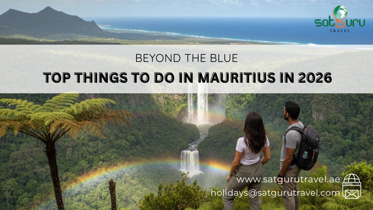 Two travelers overlooking a lush valley with waterfalls and a rainbow in Mauritius; guide on top things to do in 2026 for UAE travelers.